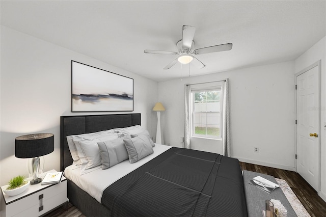 bedroom with ceiling fan and dark hardwood / wood-style floors