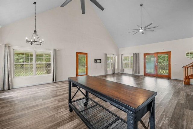 dining room featuring hardwood / wood-style floors, ceiling fan with notable chandelier, and high vaulted ceiling