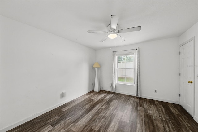 empty room with ceiling fan and dark hardwood / wood-style floors