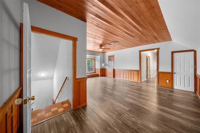 unfurnished room with vaulted ceiling, ceiling fan, wooden ceiling, hardwood / wood-style floors, and wood walls