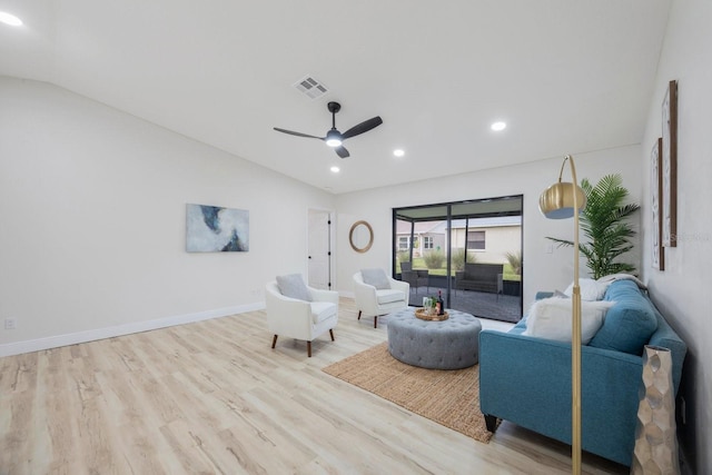 living room with lofted ceiling, ceiling fan, and light hardwood / wood-style floors