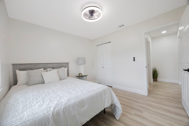 bedroom featuring light hardwood / wood-style flooring and a closet