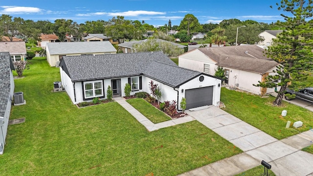 view of front of home with a garage, a front yard, and central air condition unit