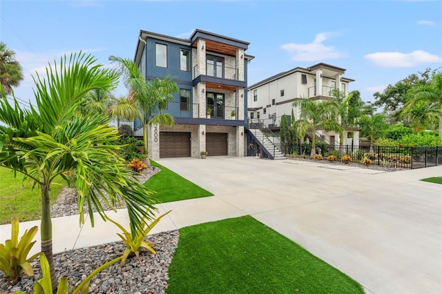 contemporary house with a garage and a balcony