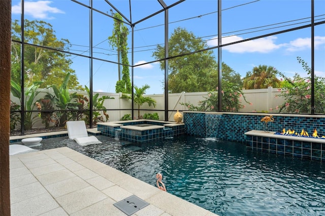 view of pool featuring an in ground hot tub, pool water feature, a lanai, and a patio