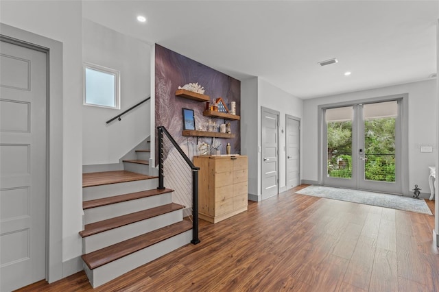 interior space featuring french doors, a healthy amount of sunlight, and hardwood / wood-style floors