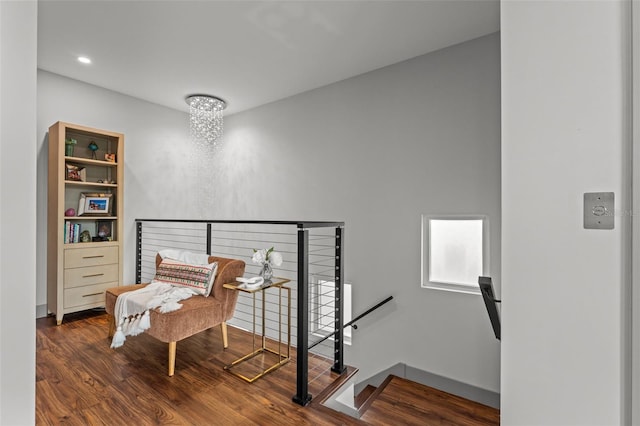 living area with an inviting chandelier and wood-type flooring