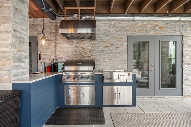 view of patio featuring grilling area, french doors, and exterior kitchen