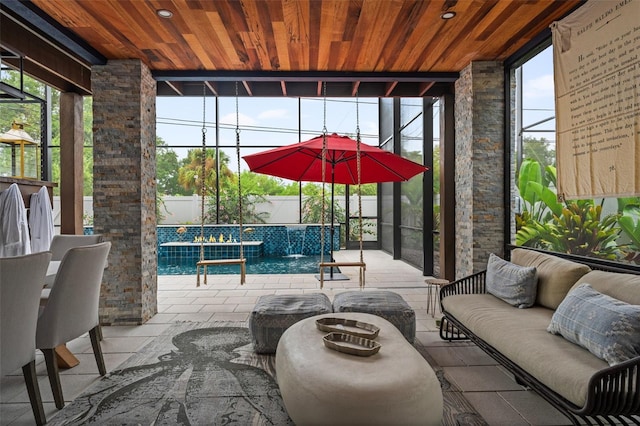 view of patio featuring an outdoor living space, pool water feature, and glass enclosure