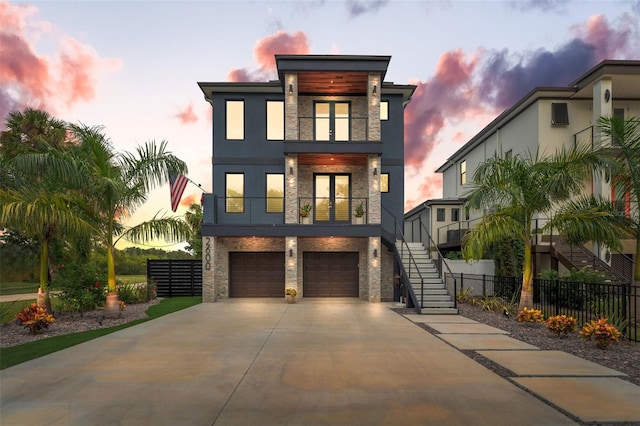 contemporary house with a garage and a balcony