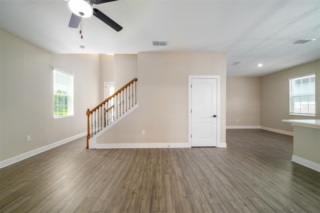 unfurnished room featuring ceiling fan, dark hardwood / wood-style flooring, and a textured ceiling