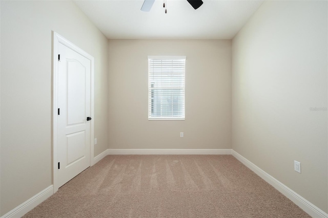 unfurnished room featuring light colored carpet and ceiling fan