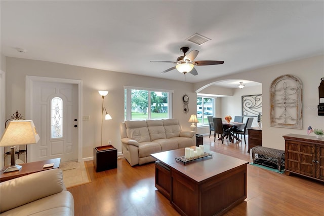 living room featuring light wood-type flooring and ceiling fan