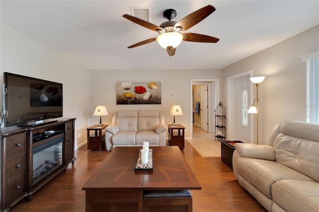 living room featuring ceiling fan and hardwood / wood-style floors