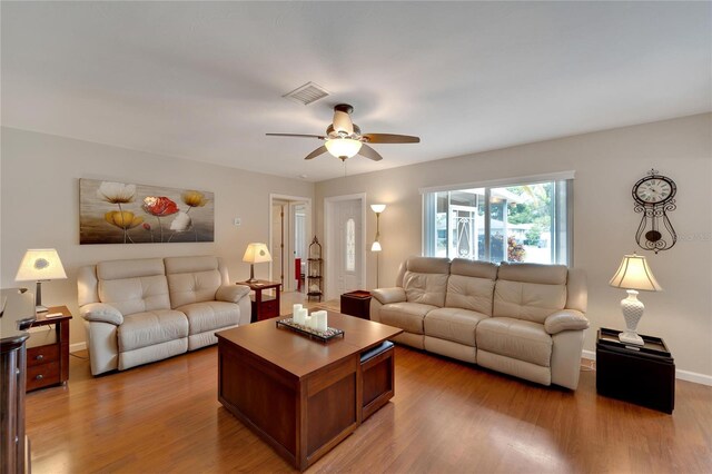 living room with ceiling fan and light wood-type flooring