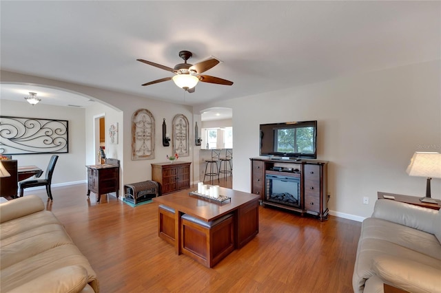 living room with ceiling fan and light hardwood / wood-style floors