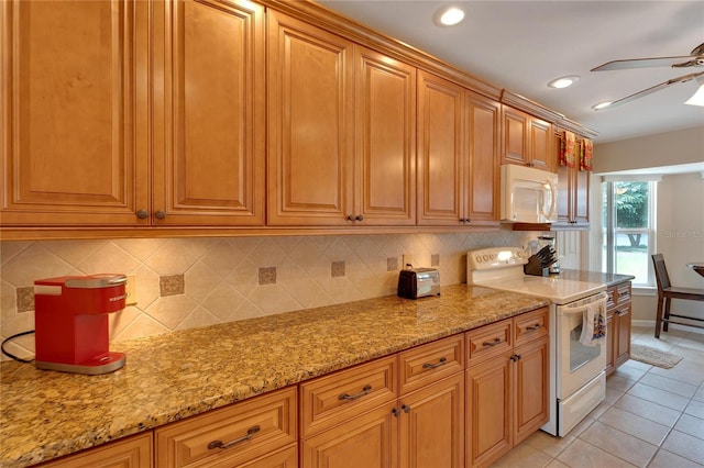 kitchen with white appliances, ceiling fan, light stone counters, and light tile patterned floors