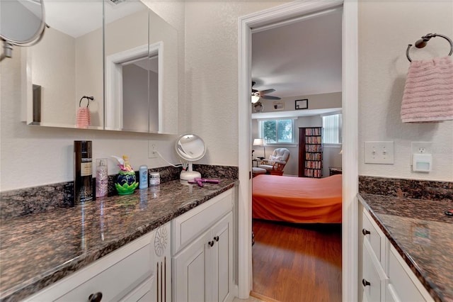 bathroom with ceiling fan, vanity, and hardwood / wood-style floors