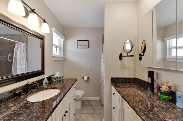 bathroom with vanity, toilet, and a wealth of natural light