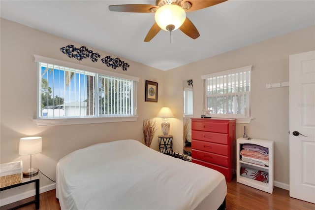 bedroom with ceiling fan and dark wood-type flooring