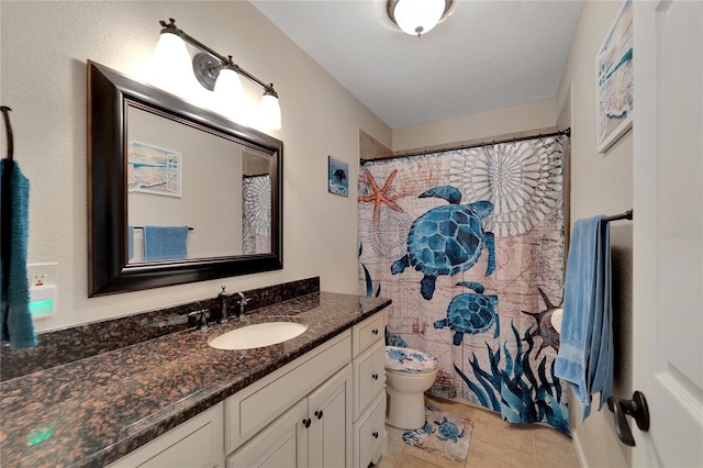 bathroom featuring tile patterned floors, a textured ceiling, vanity, and toilet