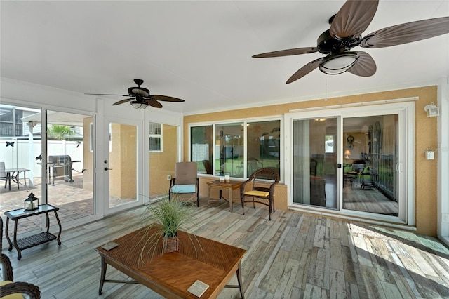 sunroom / solarium featuring ceiling fan