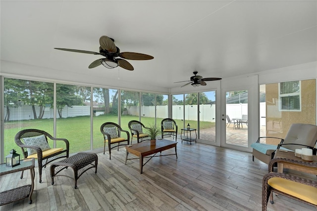 sunroom featuring a healthy amount of sunlight and ceiling fan