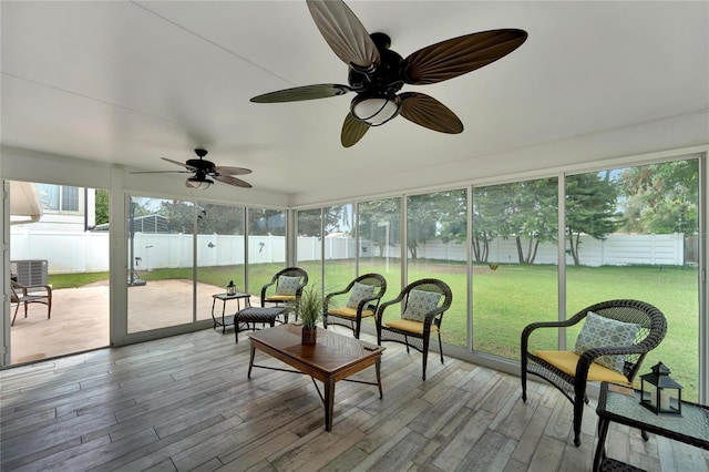 sunroom featuring ceiling fan and plenty of natural light