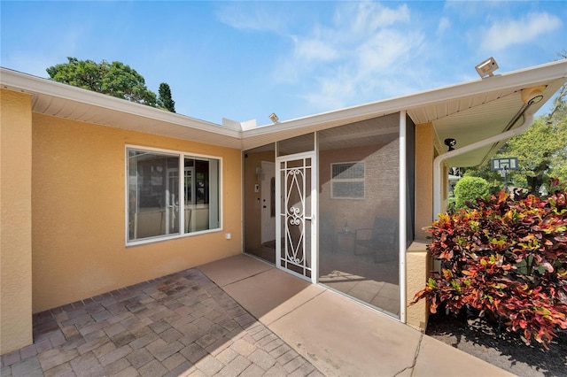 doorway to property with a patio area