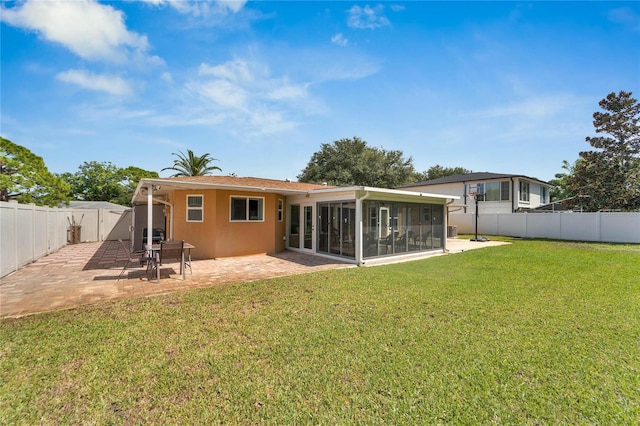 back of house with a sunroom, a yard, and a patio