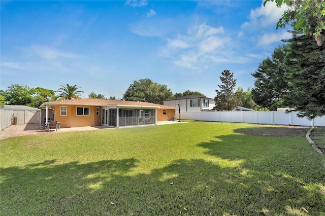 view of yard with a sunroom and a patio