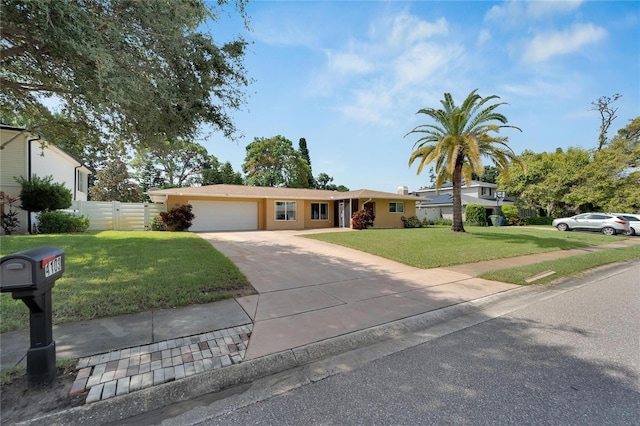 ranch-style home with a garage and a front lawn