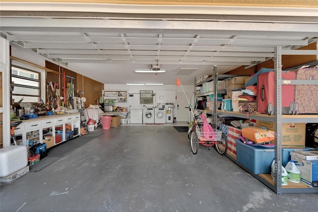 garage featuring water heater and separate washer and dryer