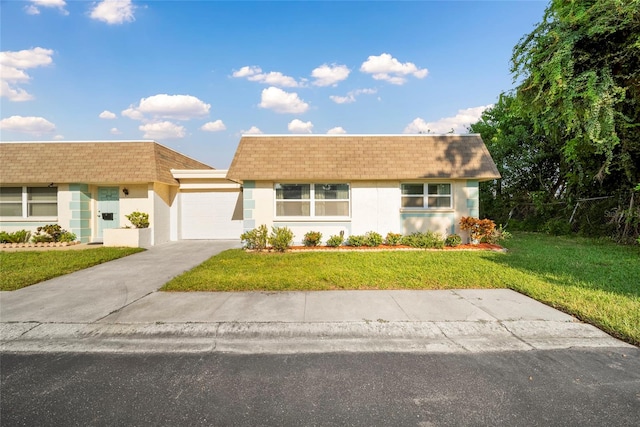 single story home with a front yard and a garage