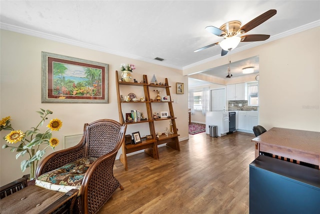 interior space featuring wood-type flooring, ornamental molding, and ceiling fan