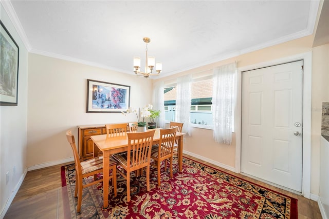 dining space featuring an inviting chandelier, ornamental molding, and hardwood / wood-style floors