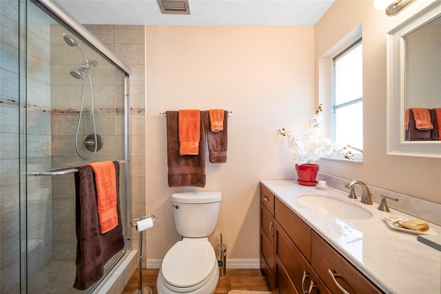 bathroom with walk in shower, wood-type flooring, vanity, and toilet