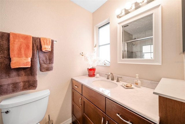 bathroom featuring walk in shower, vanity, and toilet