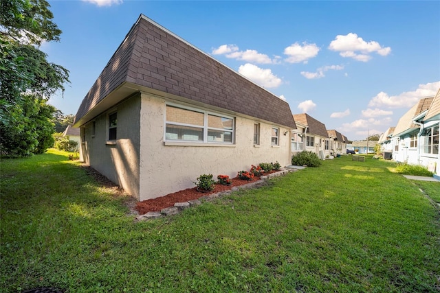 view of side of home featuring a yard