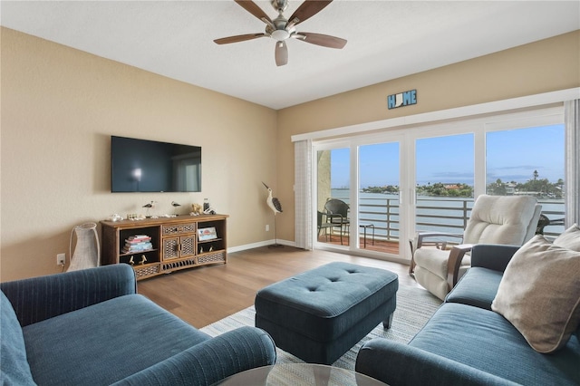 living room featuring ceiling fan and light hardwood / wood-style floors