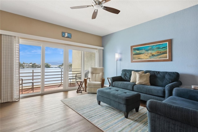 living room with light hardwood / wood-style flooring and ceiling fan