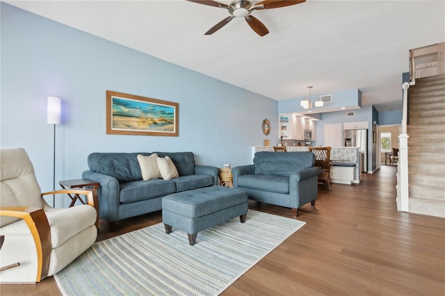 living room featuring dark hardwood / wood-style floors and ceiling fan