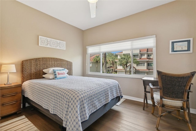 bedroom with dark hardwood / wood-style floors and ceiling fan