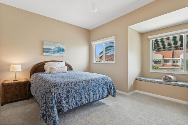 carpeted bedroom featuring multiple windows