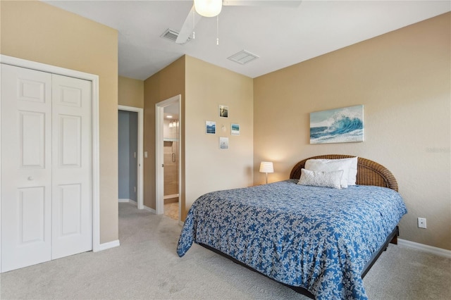 carpeted bedroom with ceiling fan, a closet, and ensuite bathroom