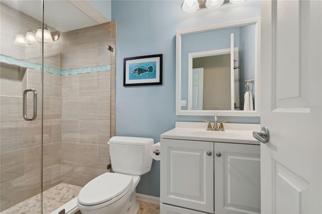 bathroom with vanity, an enclosed shower, and toilet