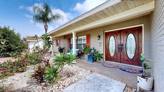 view of exterior entry with a porch