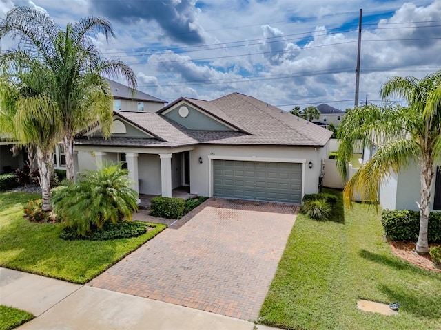 view of front of property featuring a front yard and a garage