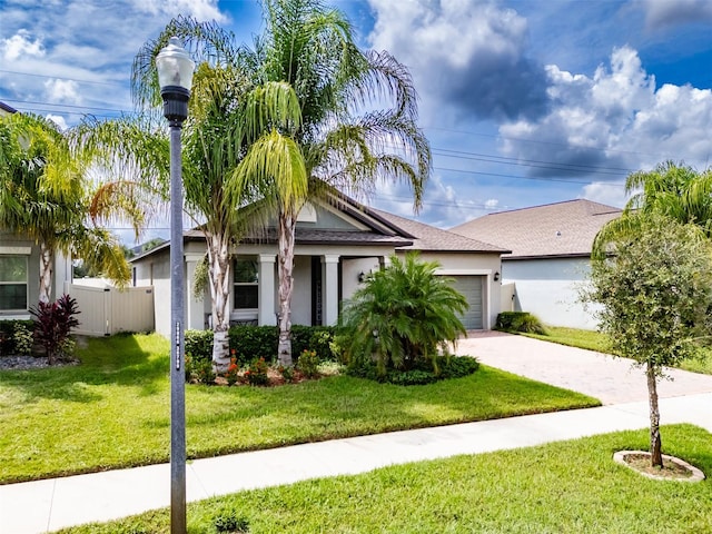 view of front of home with a garage and a front lawn