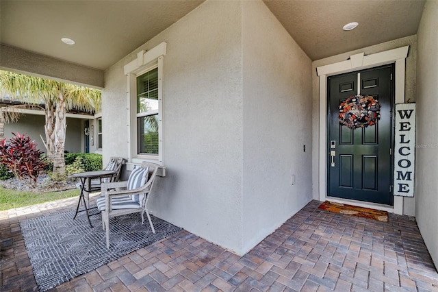 view of exterior entry with a porch